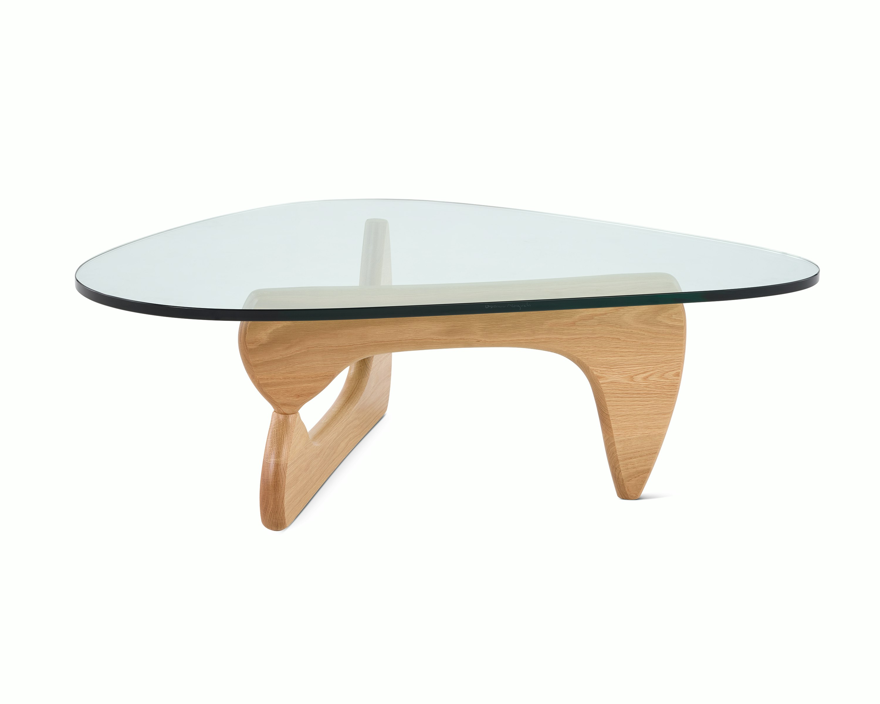A Noguchi Table with light wood base and glass top.