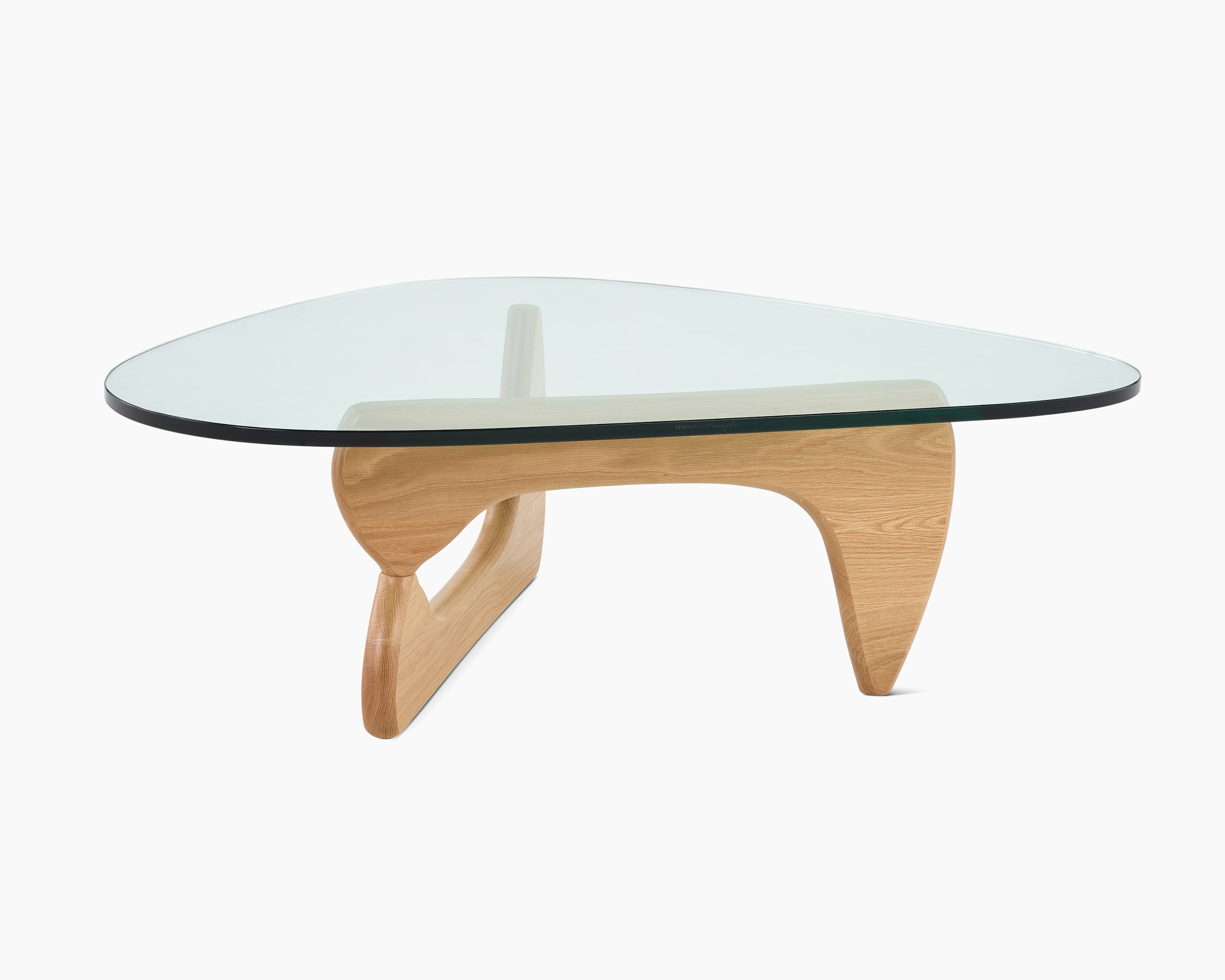 A Noguchi Table with light wood base and glass top.