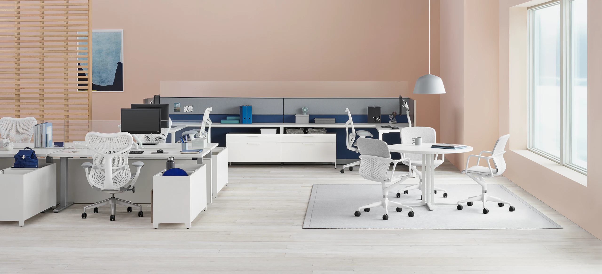 Office with Canvas Channel and Canvas Wall workstations with glass screens, white desks, lower storage, and white Mirra 2 chairs