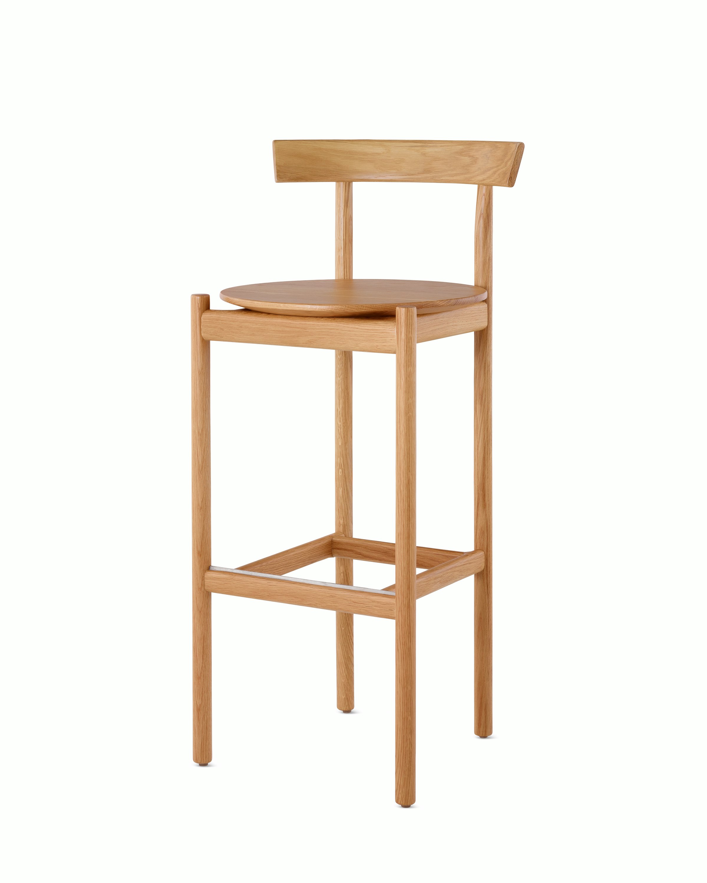 An oak bar-height Comma Stool, viewed from the front at an angle.