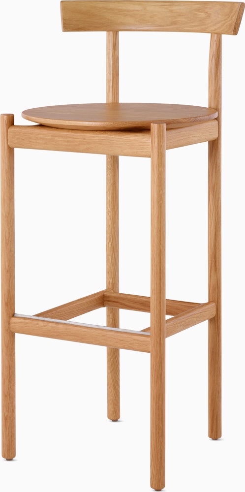 An oak bar-height Comma Stool, viewed from the front at an angle.