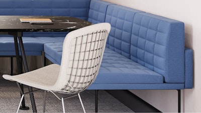 A blue Geiger Tuxedo Component Lounge, black and white Knoll Grasshopper Table, and white Knoll Bertoia chair used in a group conference room setting that considers the wellbeing of employees