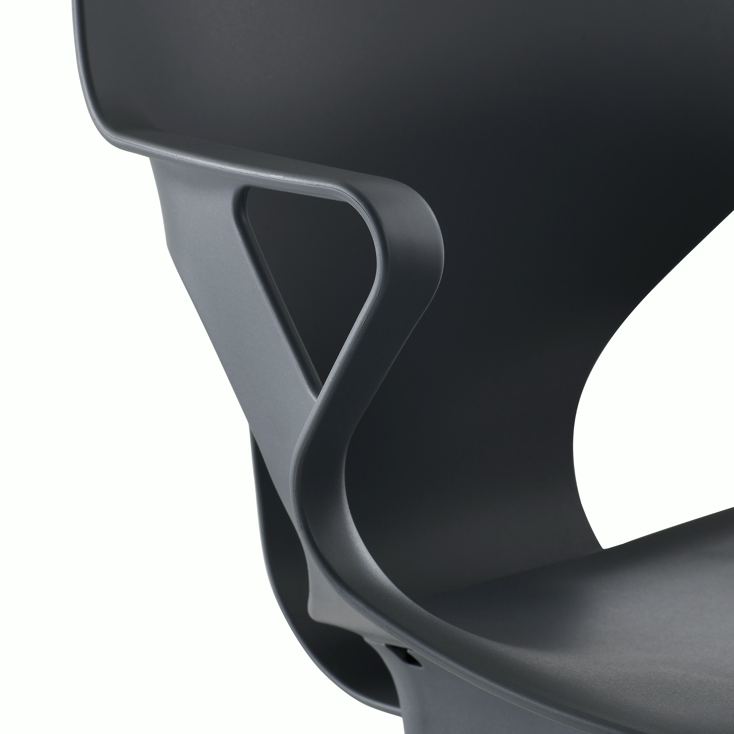 Detail view of a fixed arm of a Zeph chair in dark grey.