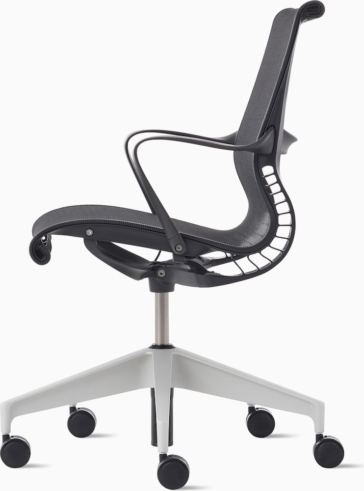 Side view of a Setu chair in dark grey with a silver alloy base.