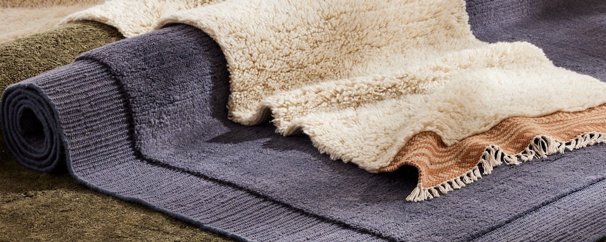 Isla Handloom Wool Rug layered with various other rugs