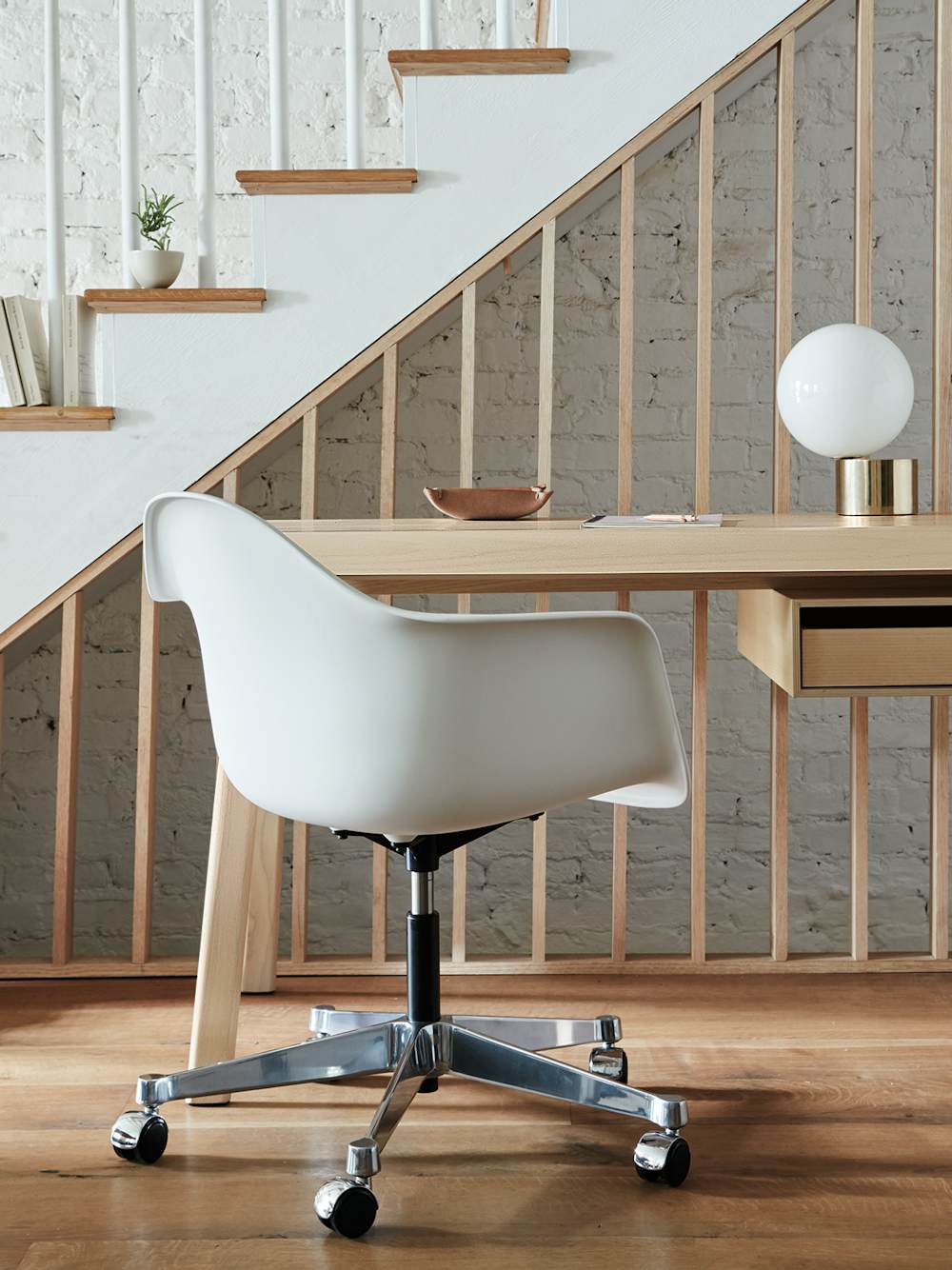 A residential work setting featuring an Eames Task Chair and Distil Desk.