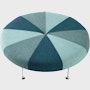 A Girard Color Wheel Ottoman upholstered in green fabrics, viewed from the top.