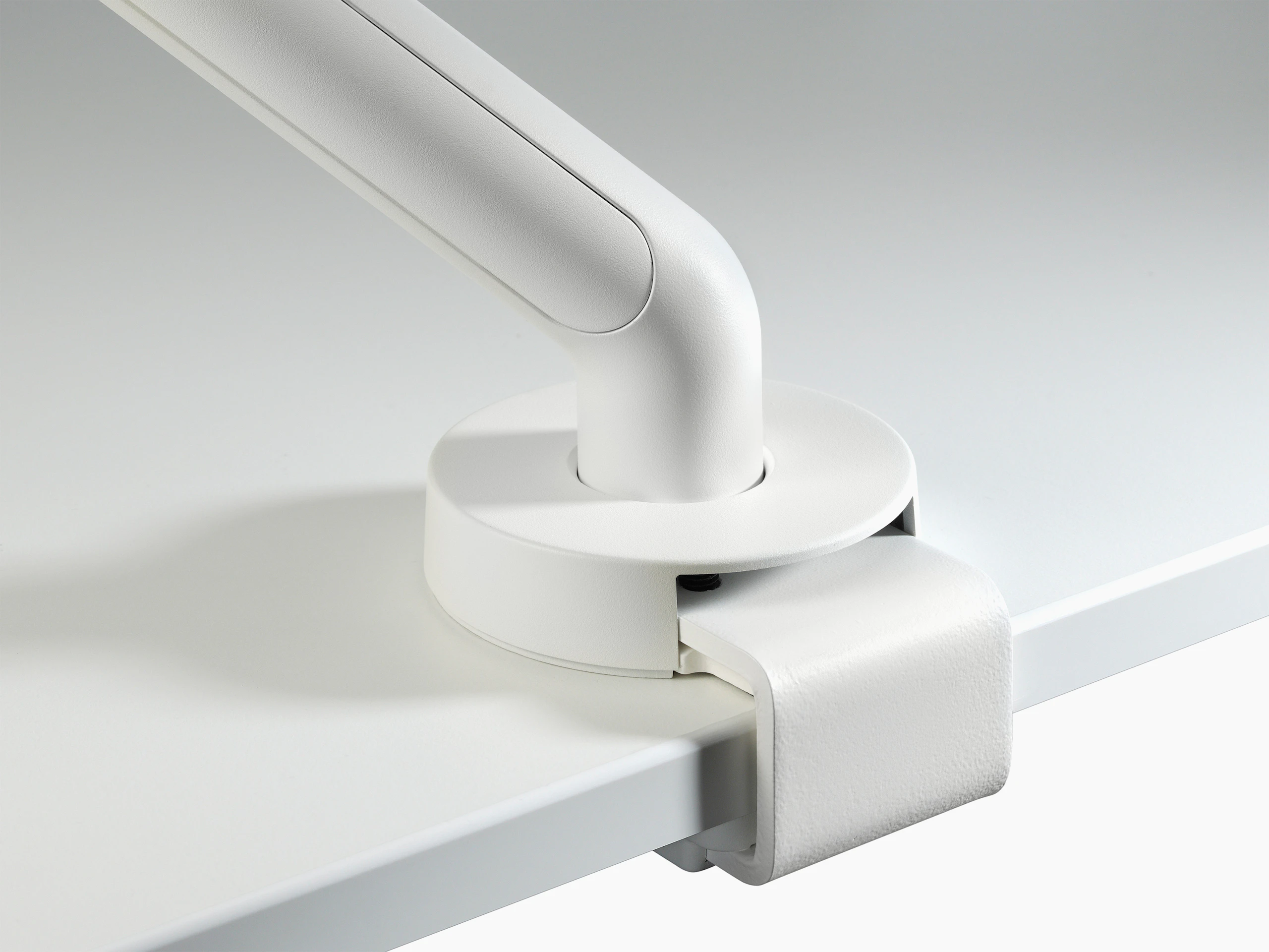 A close up of a white Flo top mount clamp.