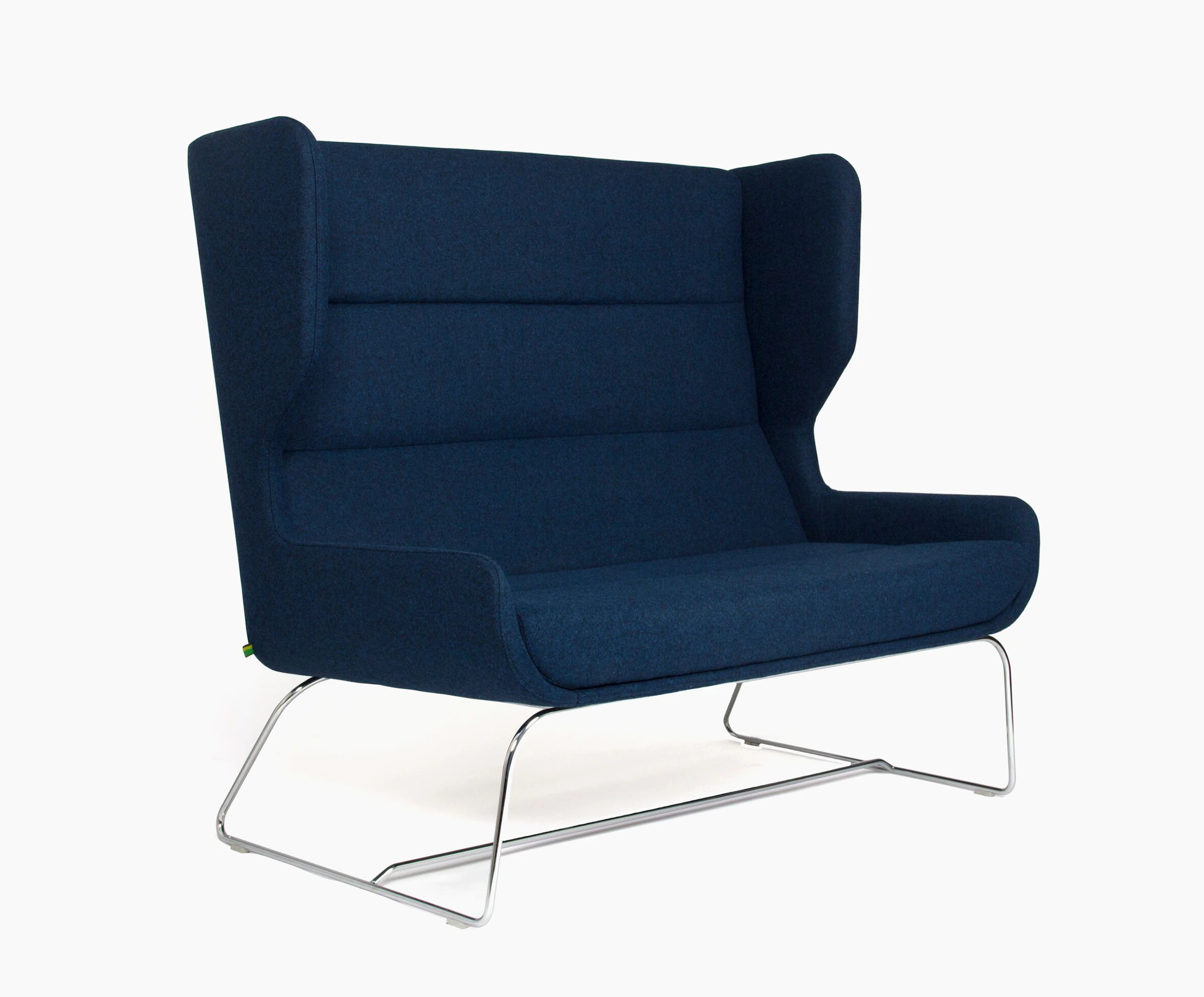 A navy high-backed Hush Sofa with a sled base, viewed at an angle.