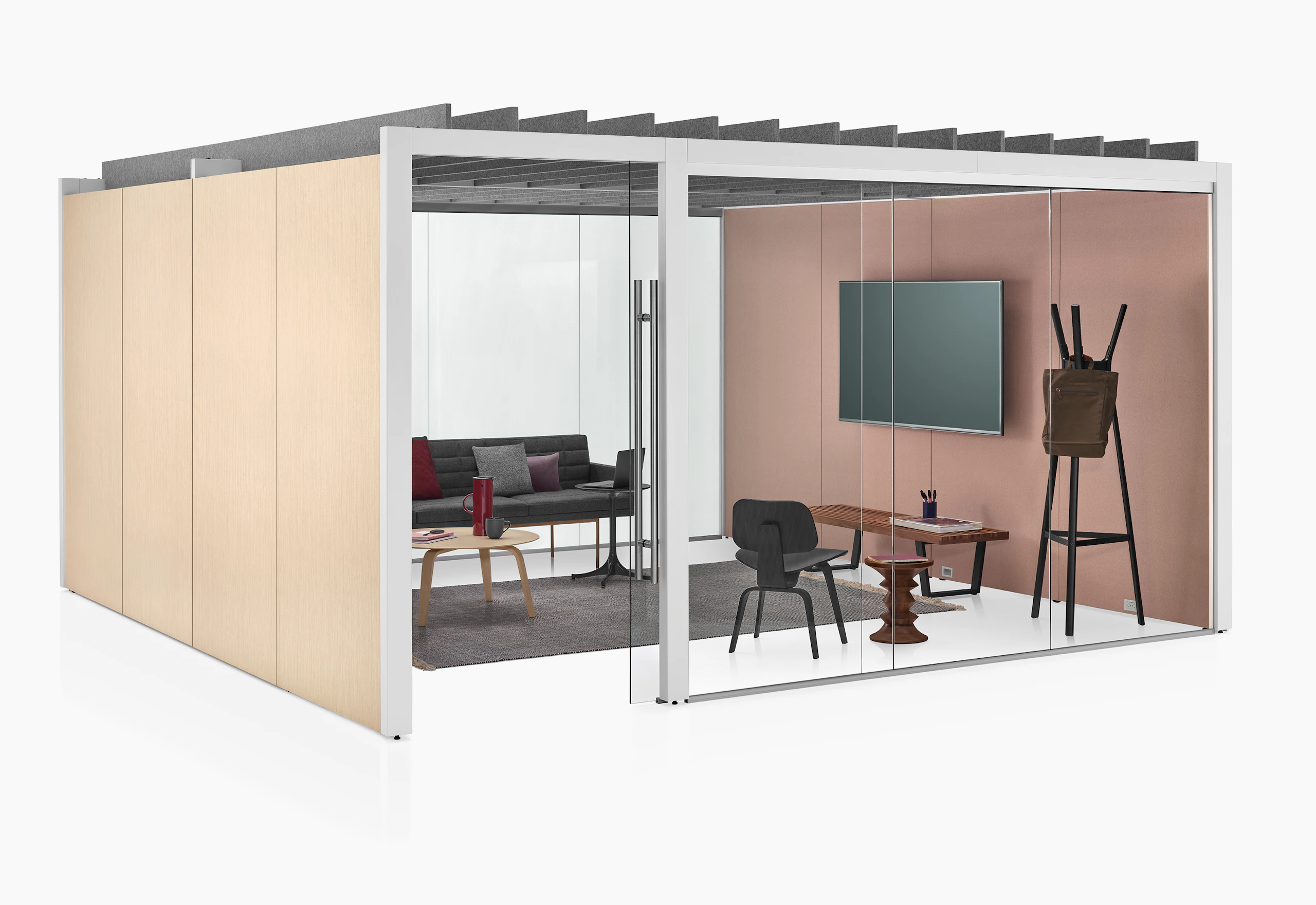 An enclosed Overlay meeting room with two glass walls and two laminate walls. A couch, bench, coat rack, coffee table, and monitor are inside Overlay.