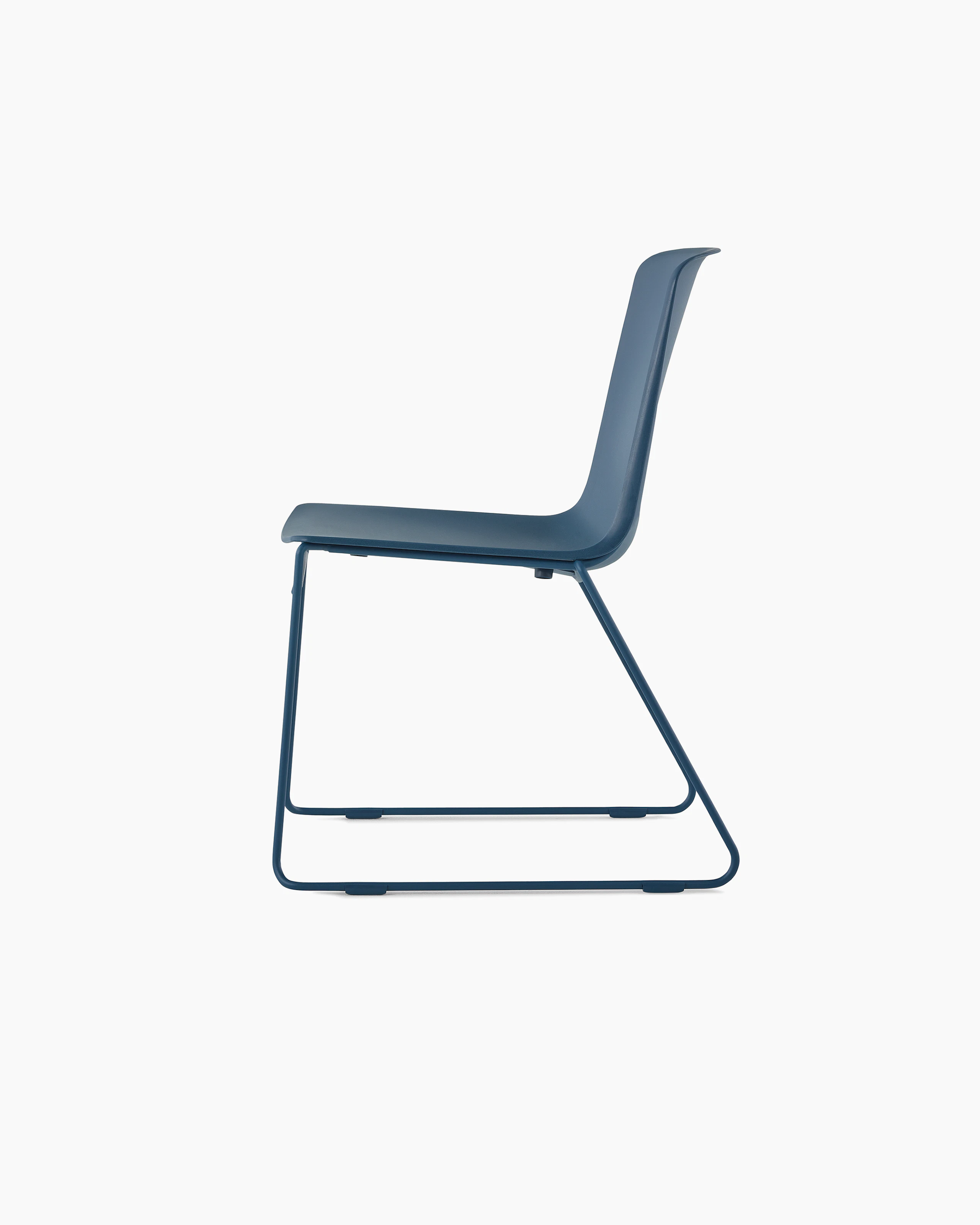 A peacock blue Pronta Stacking Chair with a dipped-in-color shell and base.