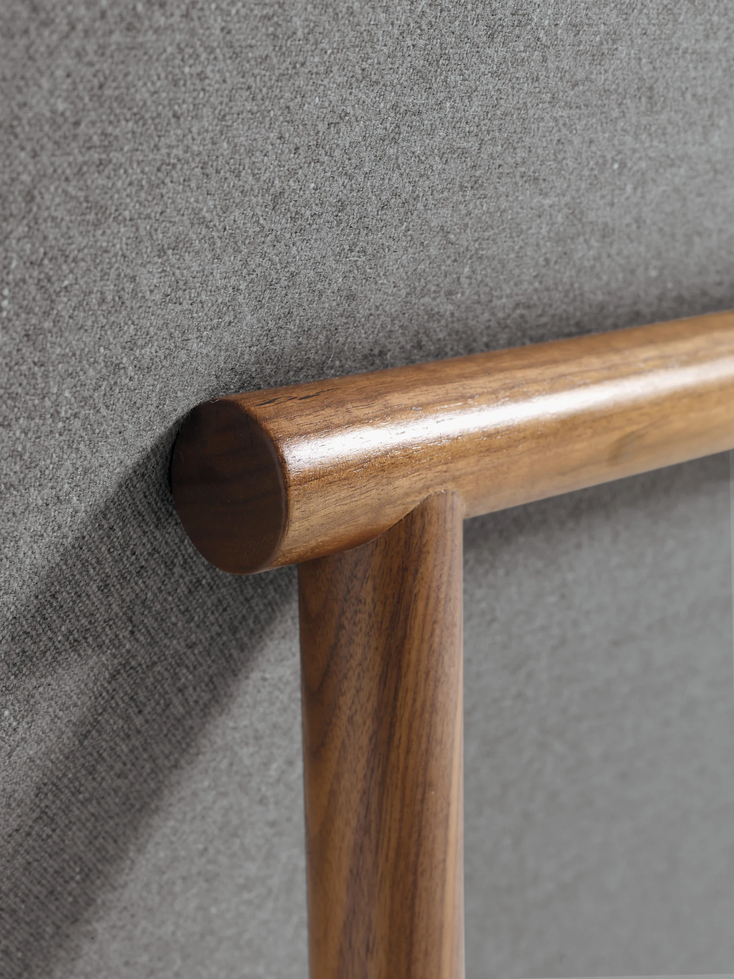 Close-up of armchair wood arm/leg corner with upholstered edge