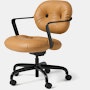 Front angle view of a Morrison Hannah chair with a black frame and base with fixed arms and light brown leather upholstery.