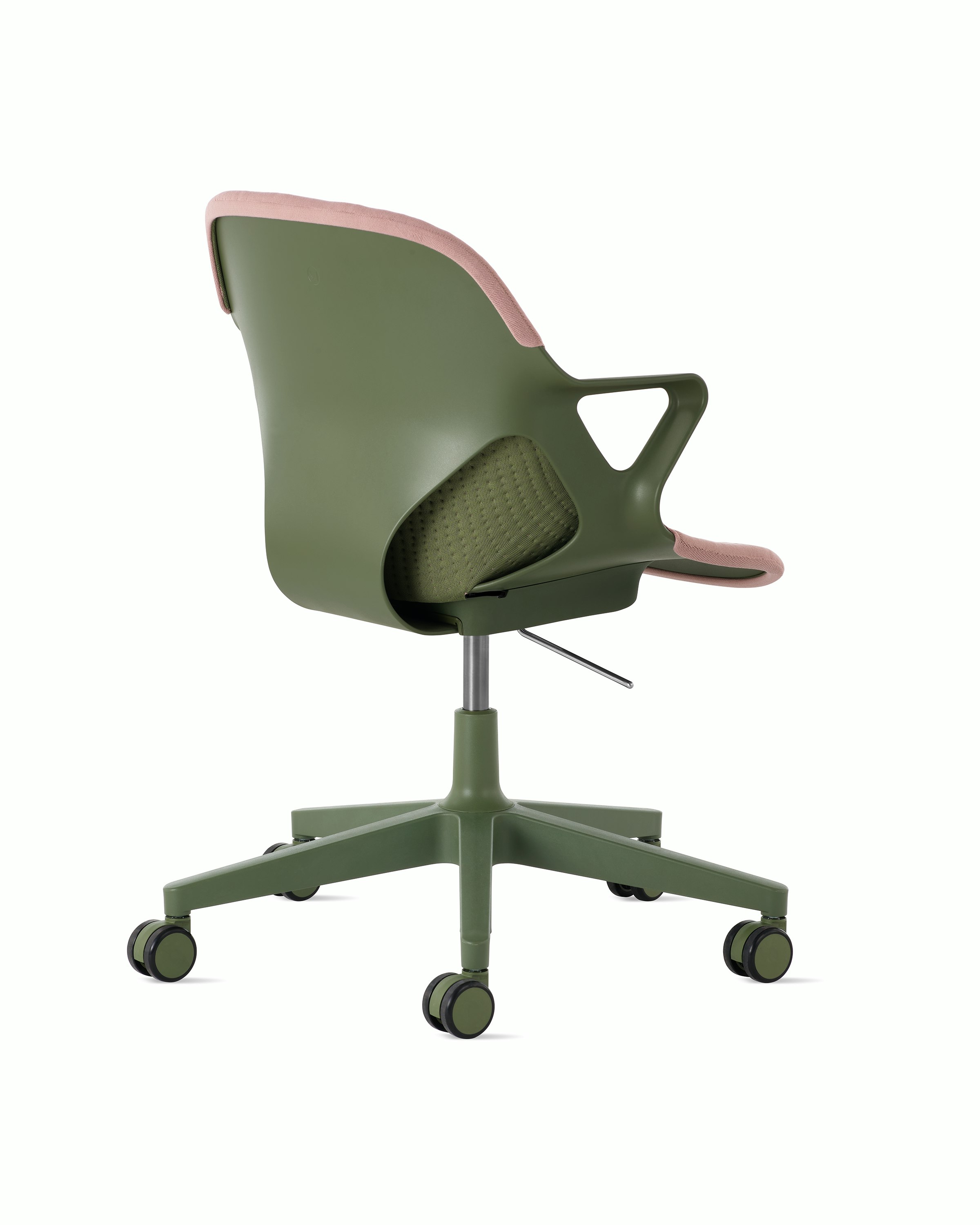 Rear angle view of a Zeph chair with fixed arms in olive with a light pink knit cover.