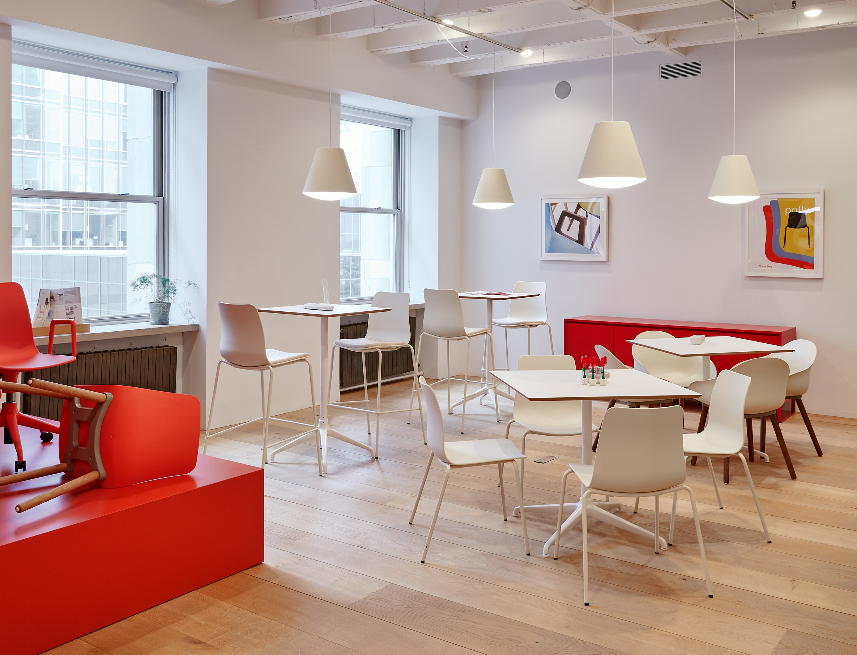 A cafe scene with white Polly chairs and barstools around Ali tables.