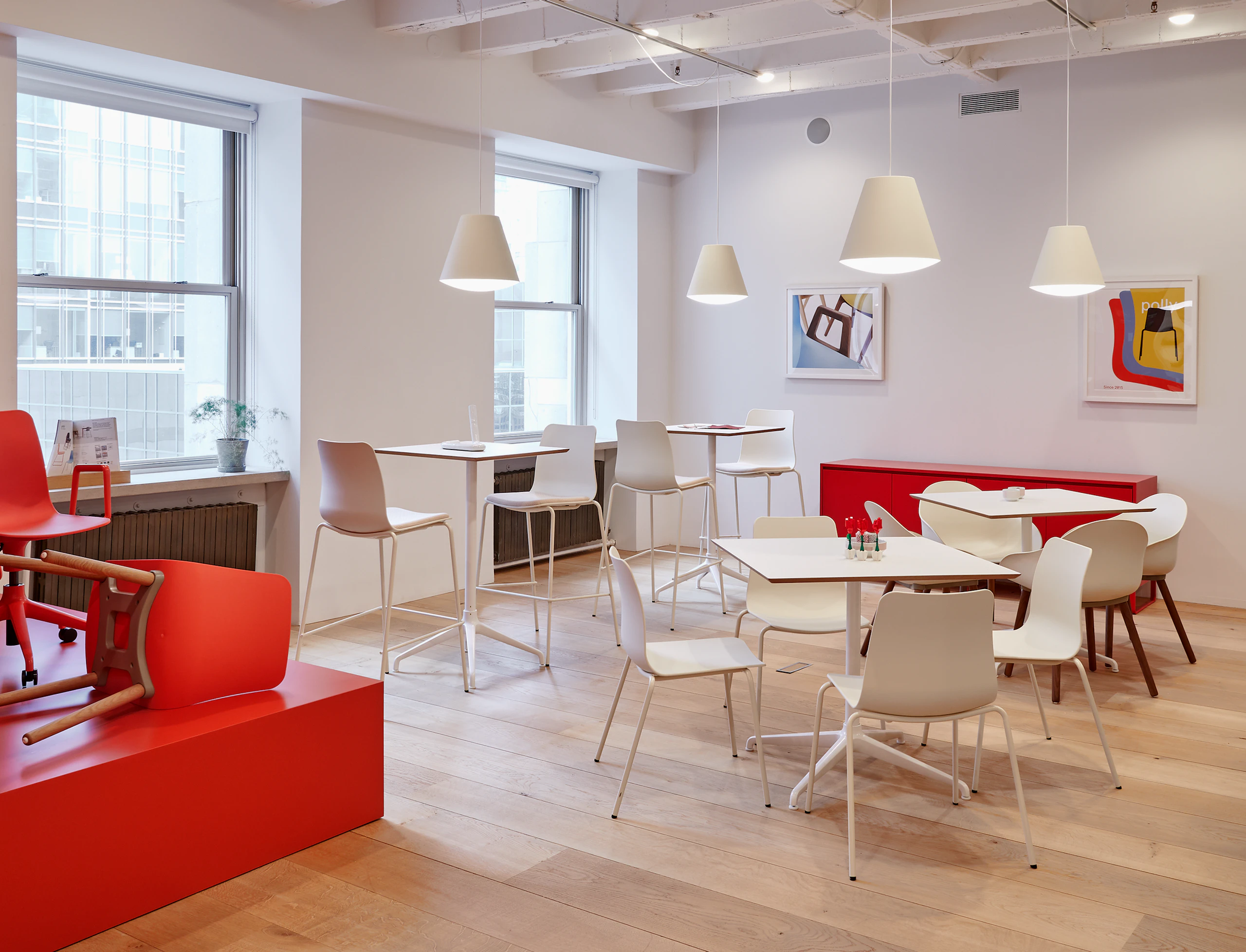 A cafe scene with white Polly chairs and barstools around Ali tables.