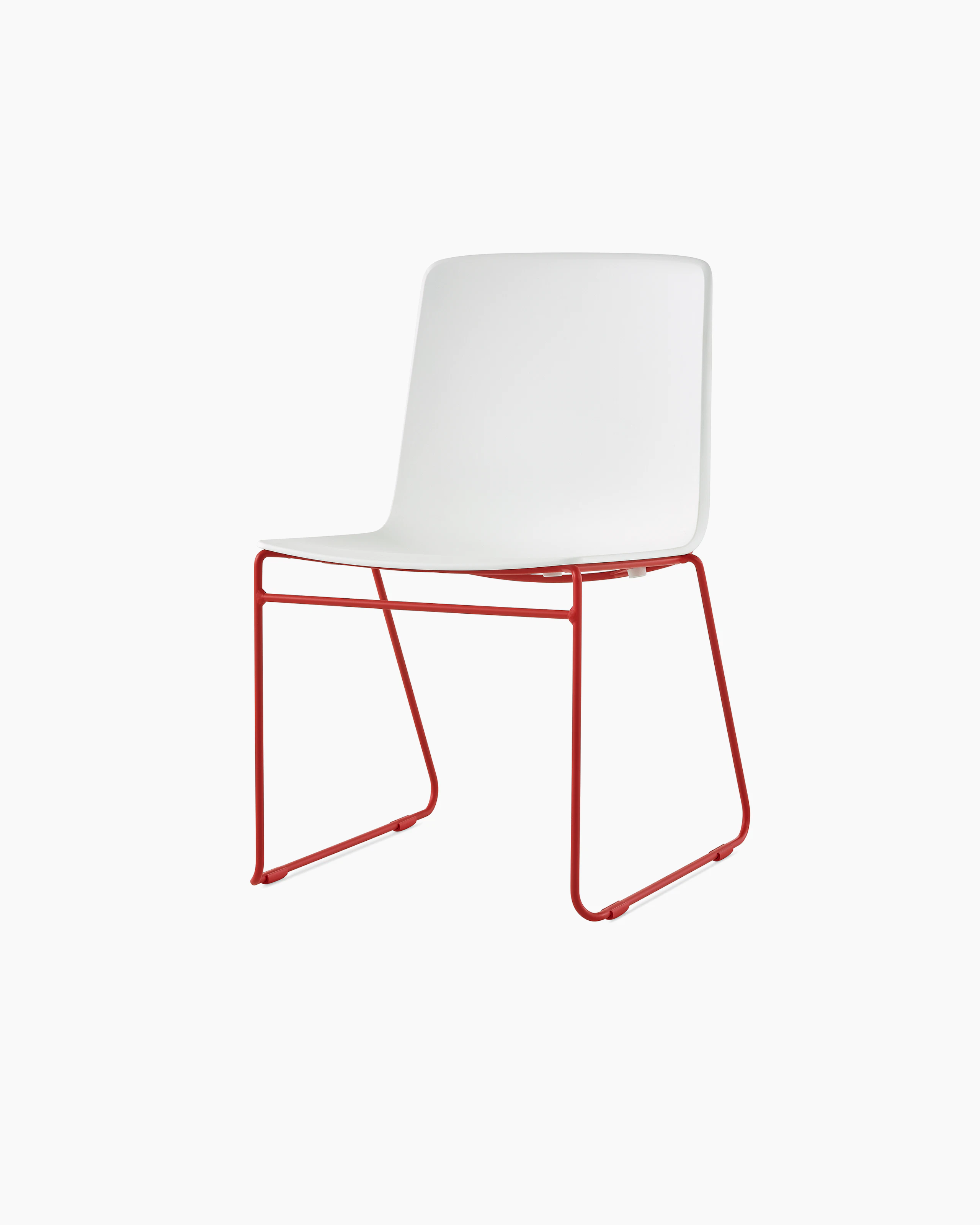 A white Pronta Stacking Chair with an atomic red base.