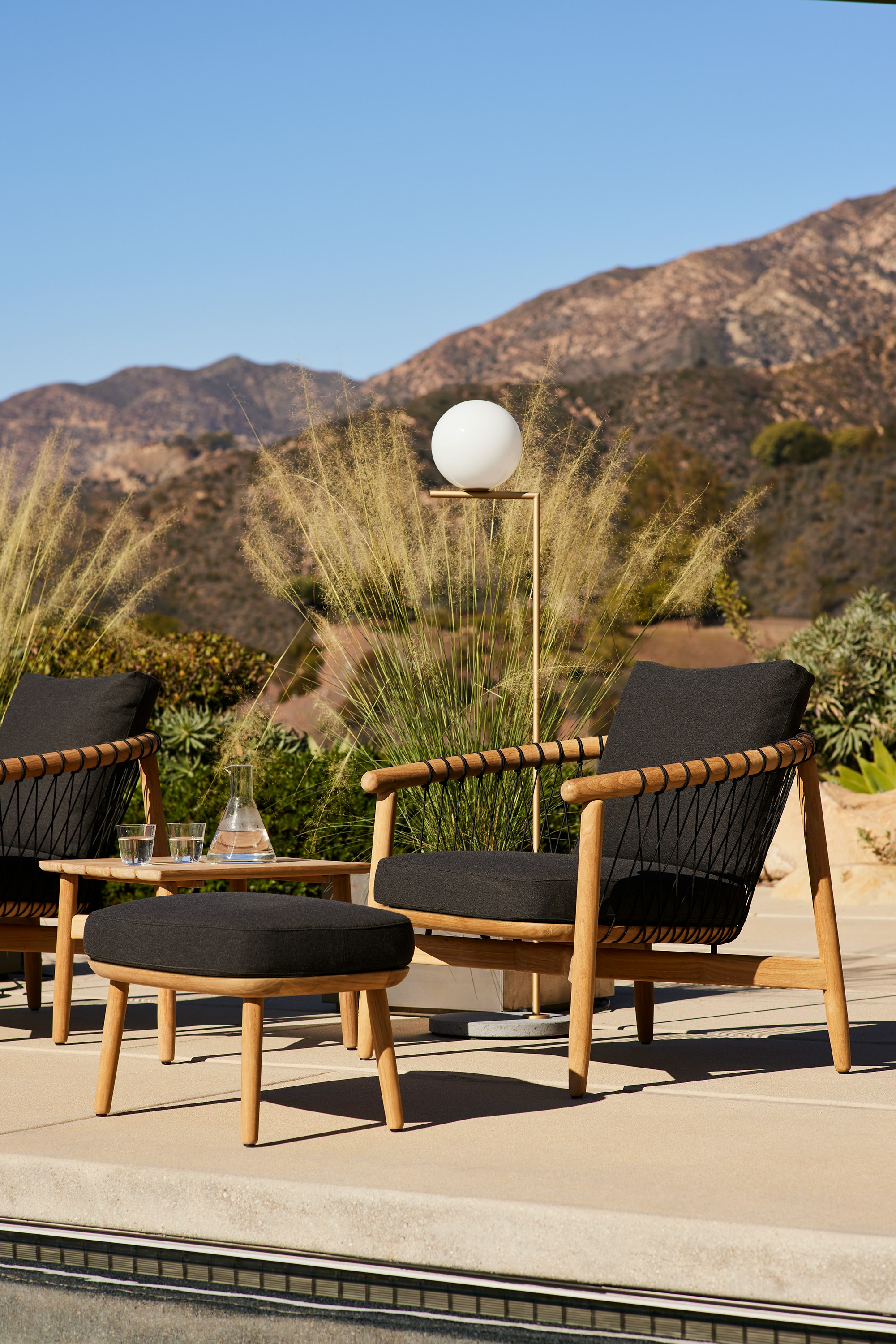 Crosshatch Outdoor Lounge and Ottoman and Square Side Table in an environmental setting.