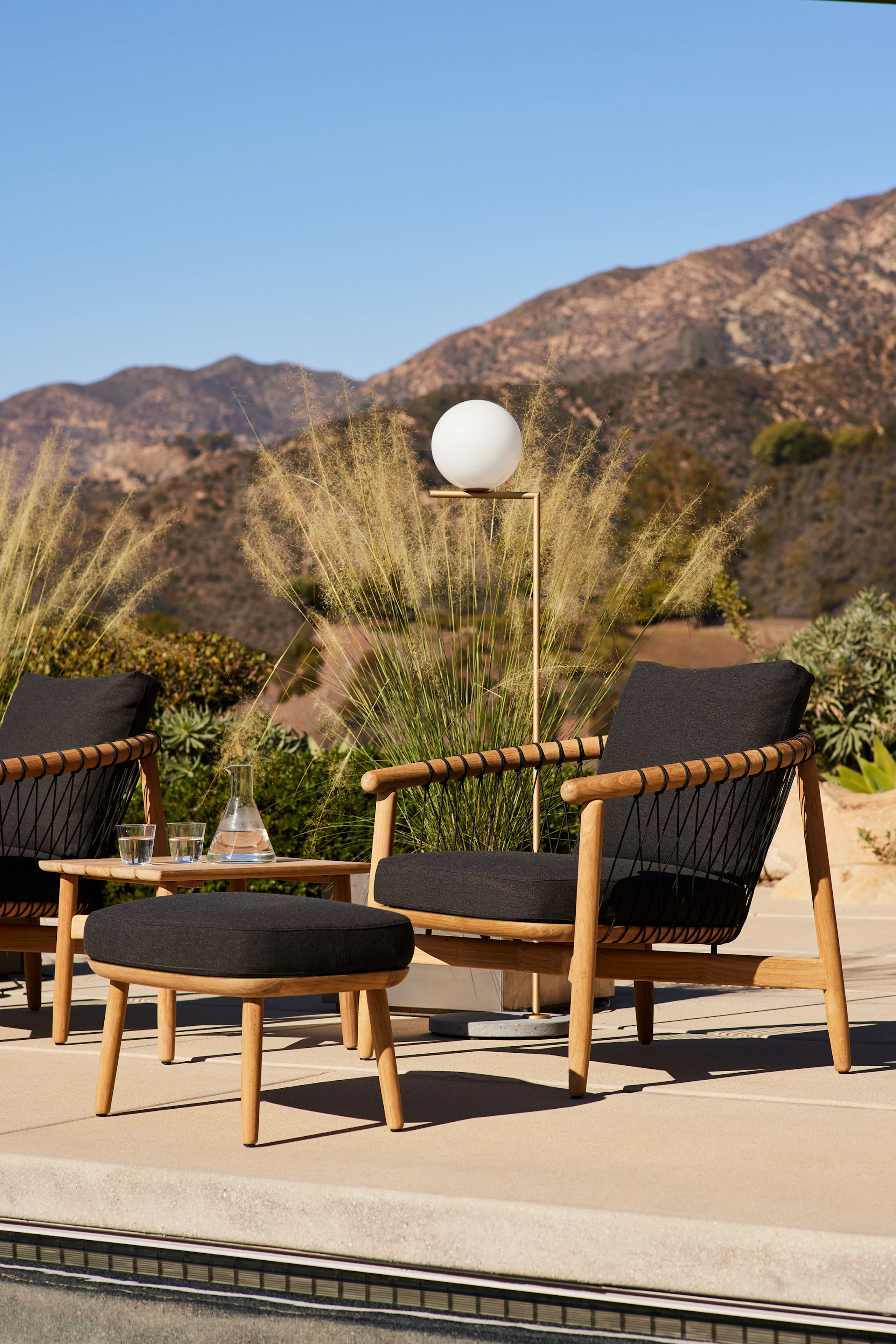 Crosshatch Outdoor Lounge and Ottoman and Square Side Table in an environmental setting.