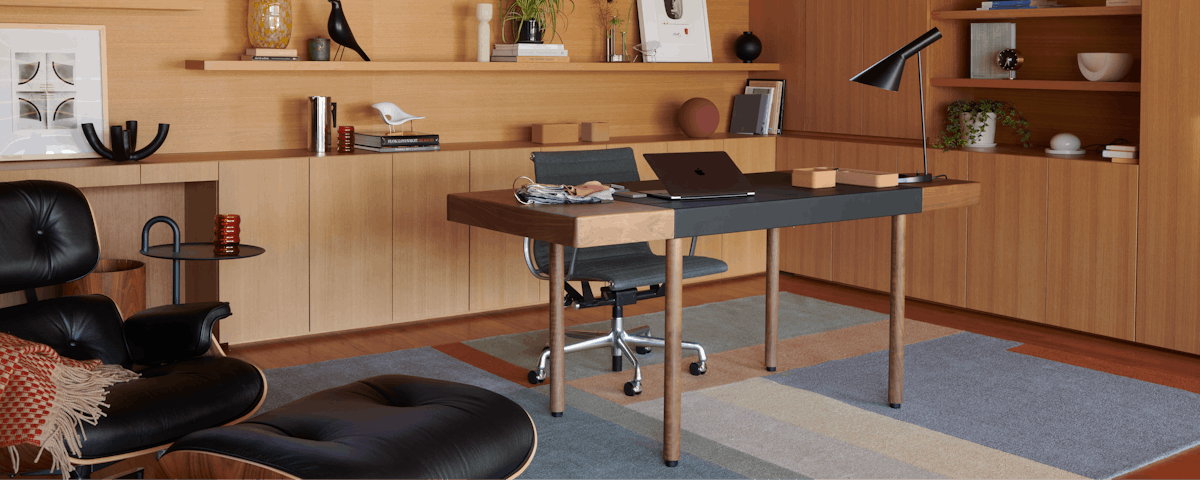 Landscape Rug, Leatherwrap Sit-to-Stand Desk, AJ Table Lamp and Eames Lounge and Ottoman in a home office setting