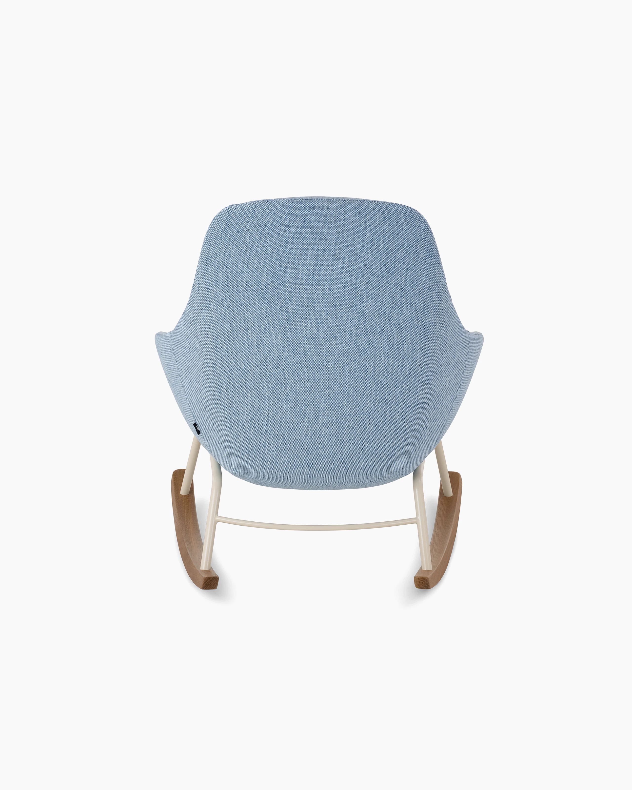 White background shot of Always Lounge Chair with pale blue fabric and rocker base.