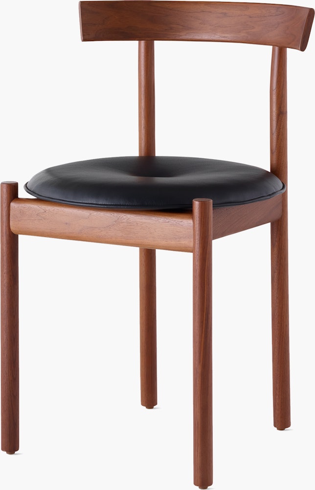A walnut Comma Chair with a seat pad, viewed from the front at an angle.