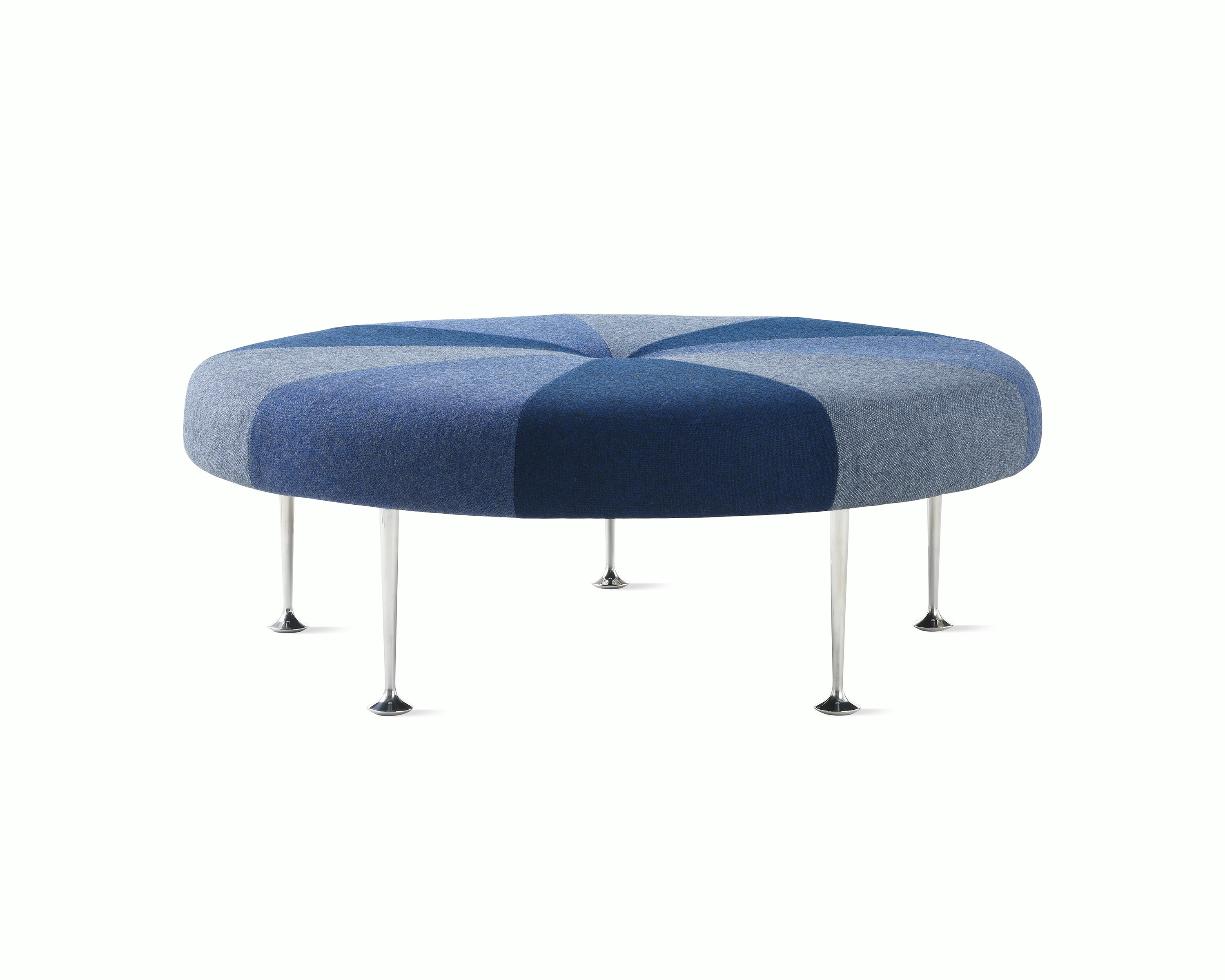 A Girard Color Wheel Ottoman upholstered in blue fabrics, viewed from the side.