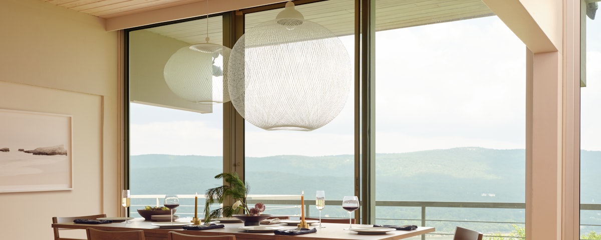 Two Non-Random Pendants above a Matera Dining Table and Matera Dining Chairs in a dining room setting