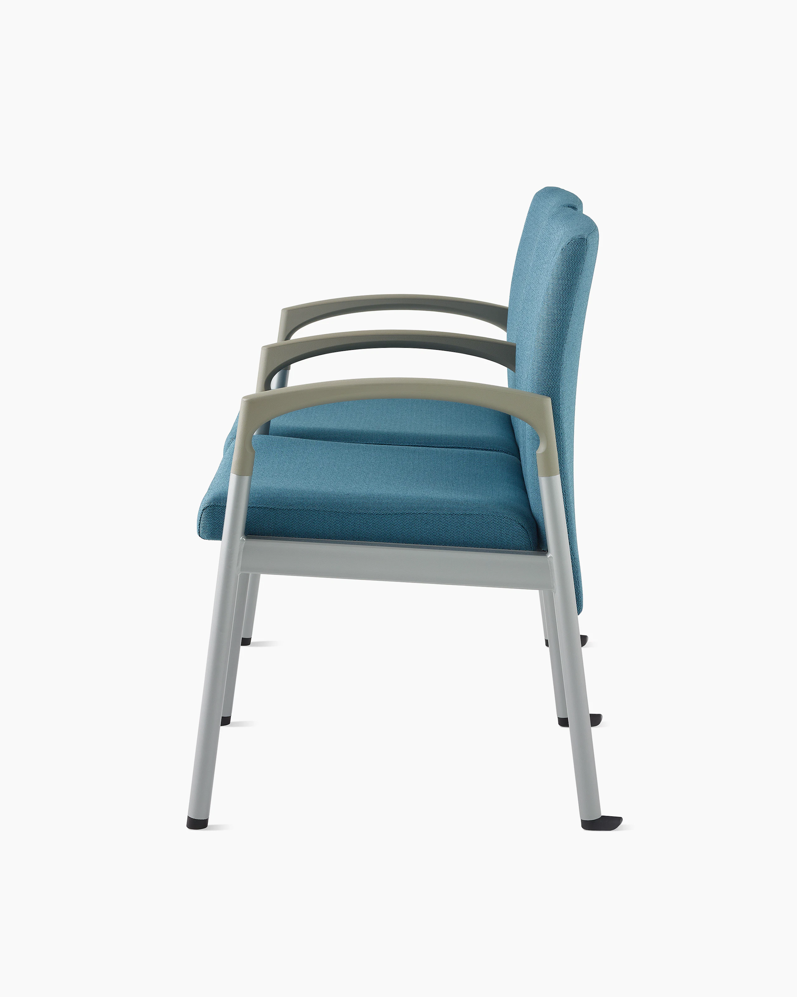 Side view of Valor two-seat multple seating with intervening arms and legs in a blue upholstery, silver frame, and pewter armcaps on white sweep.