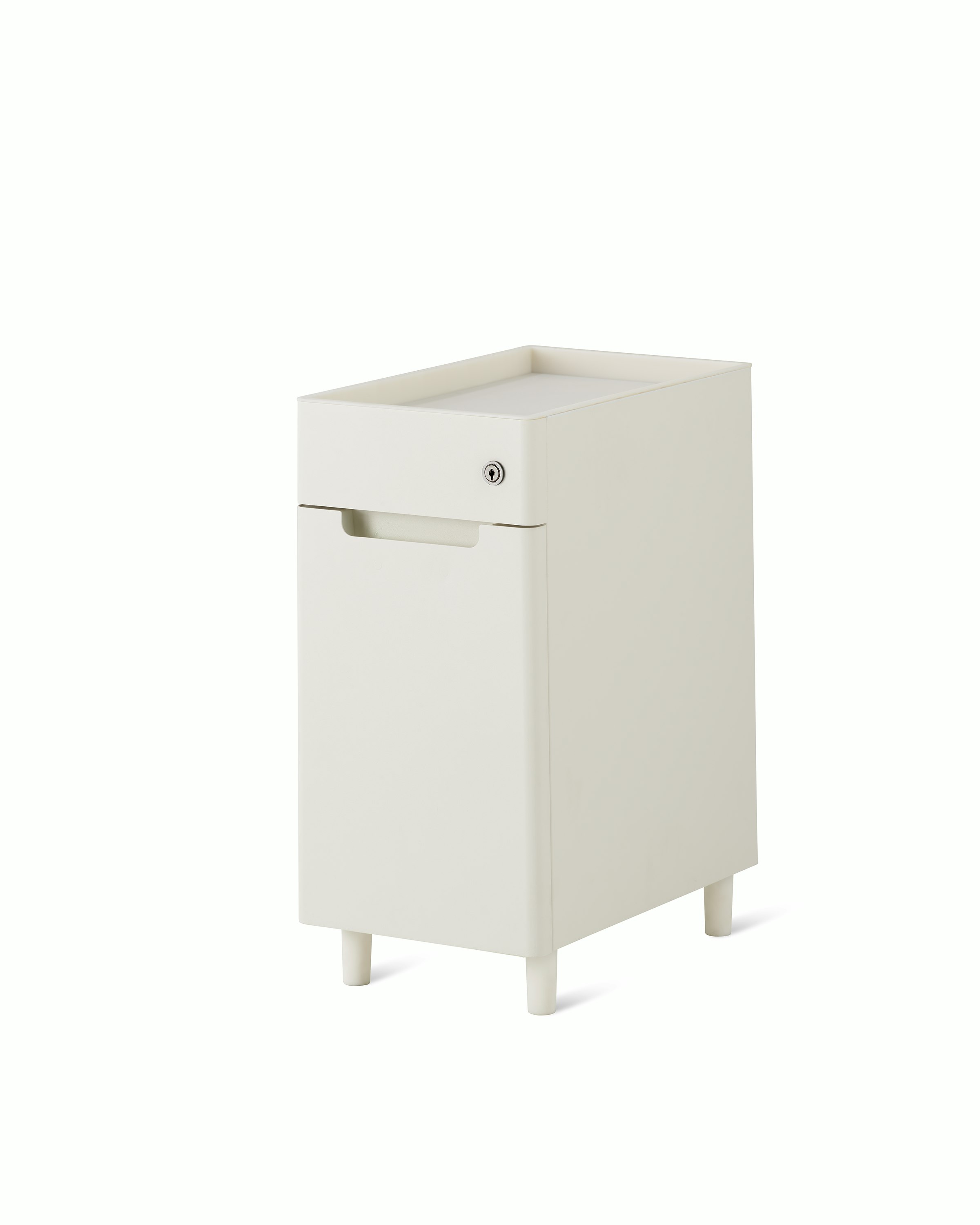 Slim, white storage pedestal on white feet with a small drawer with lock, an open tray top, and door for storage.