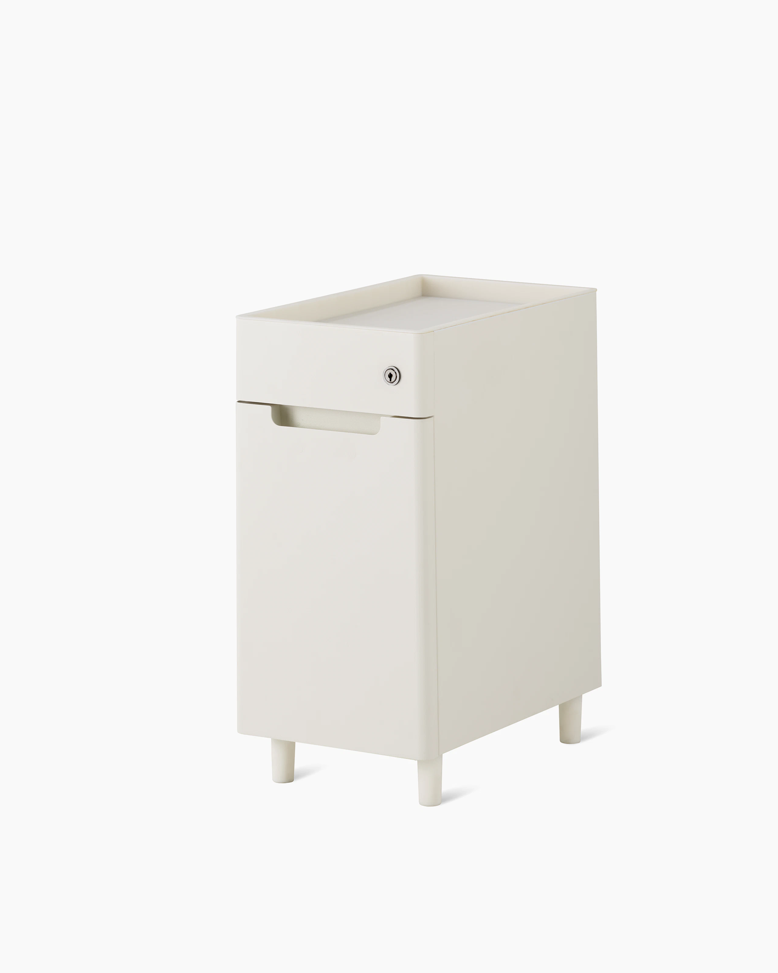 Slim, white storage pedestal on white feet with a small drawer with lock, an open tray top, and door for storage.