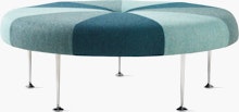 A Girard Color Wheel Ottoman upholstered in green fabrics, viewed from the side.