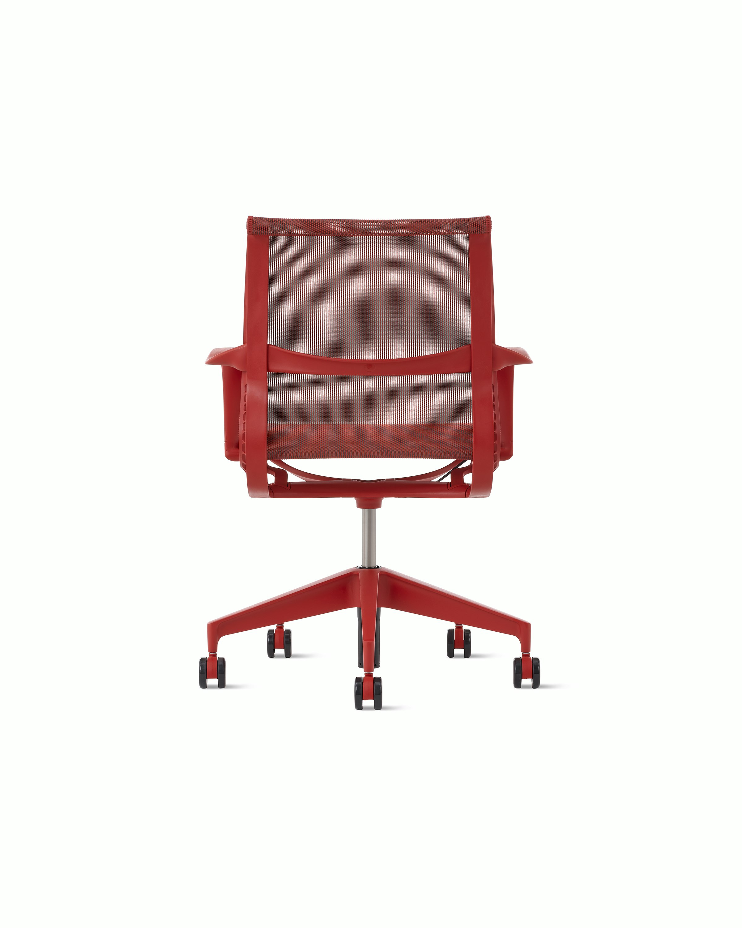 Rear view of a Setu chair with fixed arms in red.