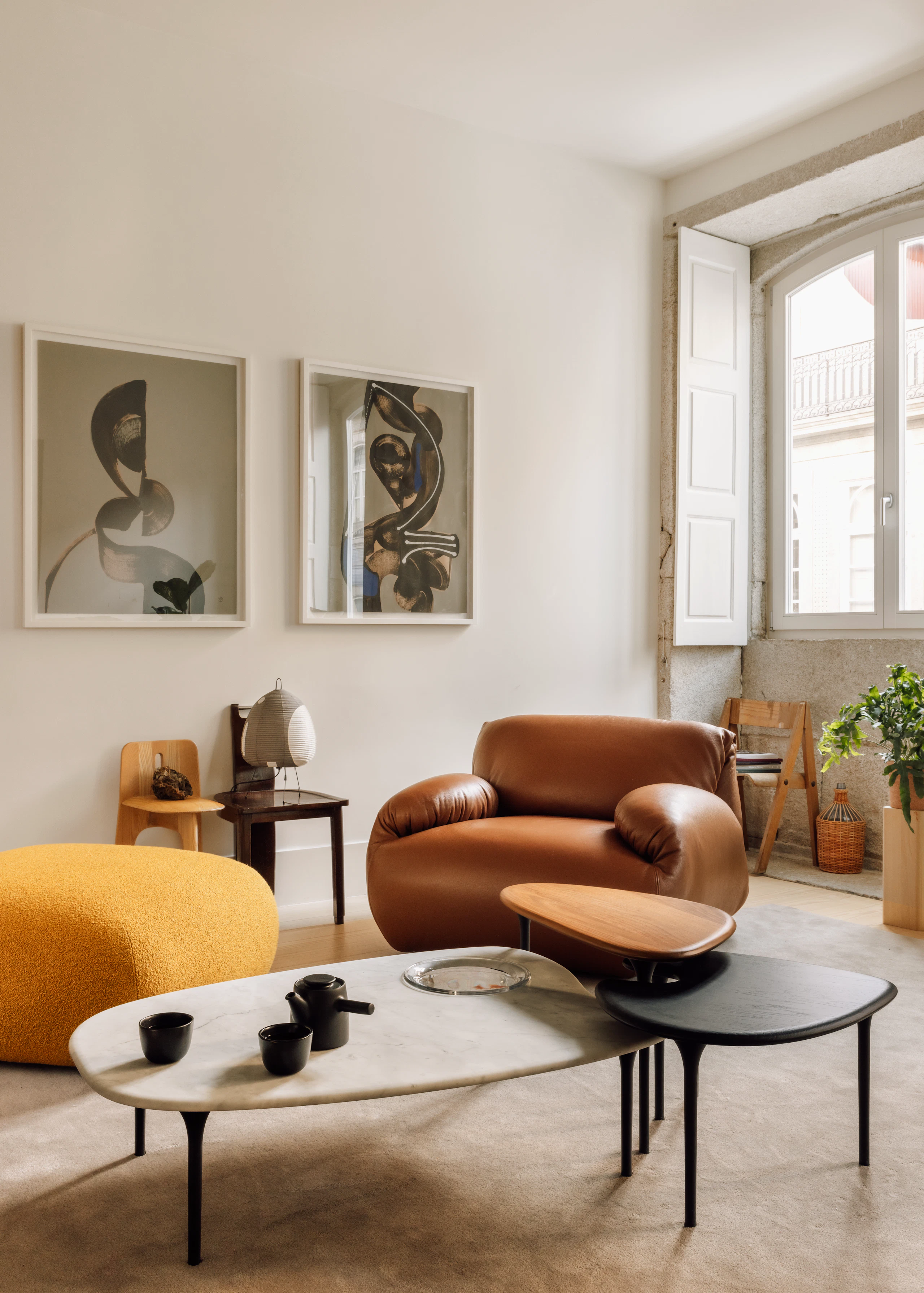 Luva Modular Sofa, Armchair in a living room with Cyclade tables in walnut, ebony, and marble