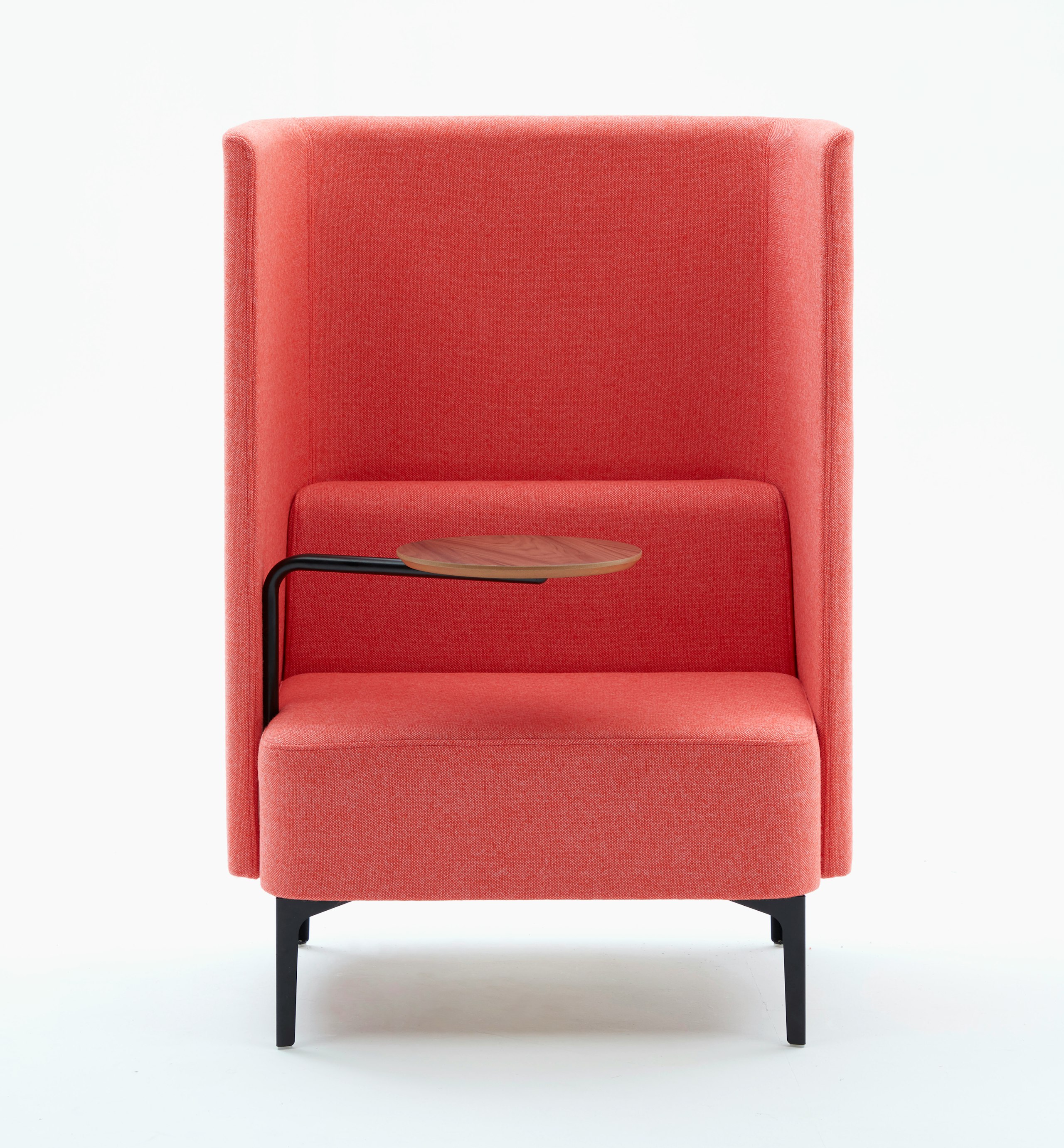 High back Pullman Chair upholstered in pink fabric, with black metal legs, and walnut veneer tablet arm on the right hand side.