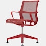 Front angle view of a Setu side chair with fixed arms in red.