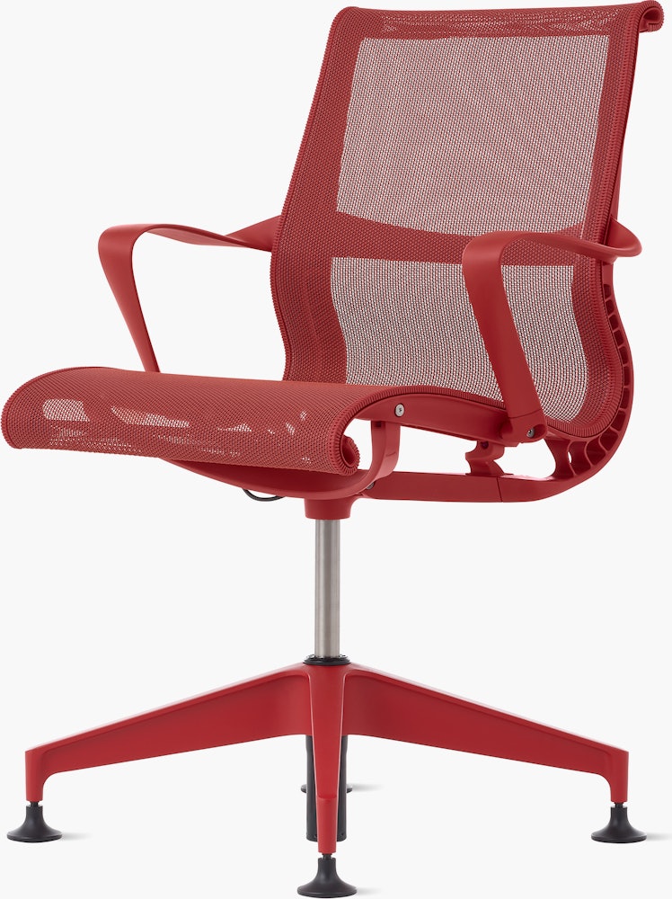 Front angle view of a Setu side chair with fixed arms in red.