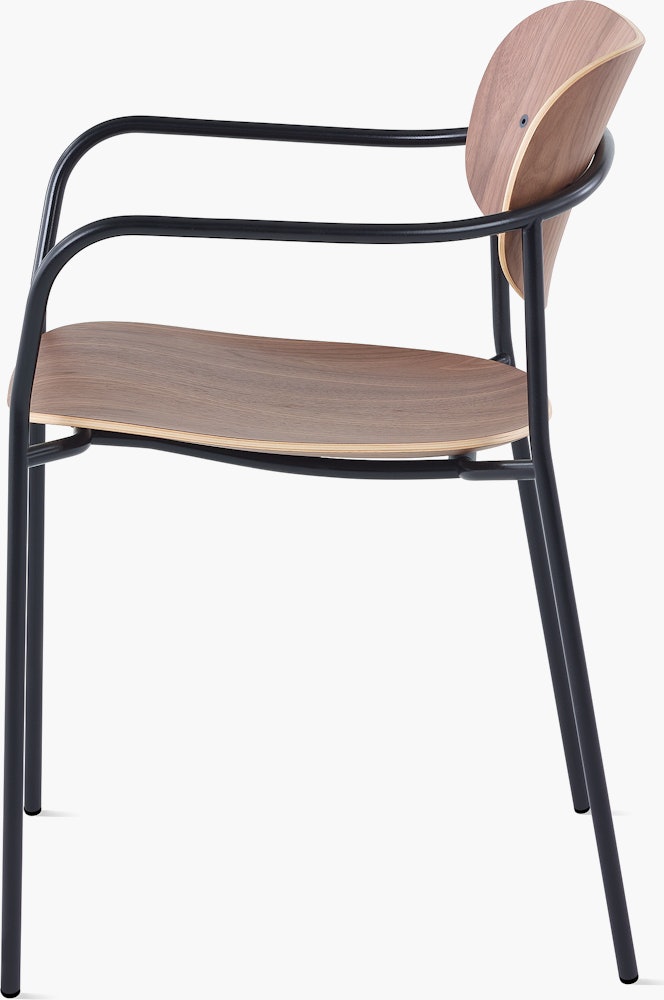 Portrait Chair with Walnut seat and back, and black frame with arms.