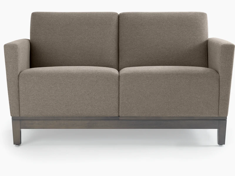 Front view of a gray two-seat Brava Platform Lounge System on wood base.