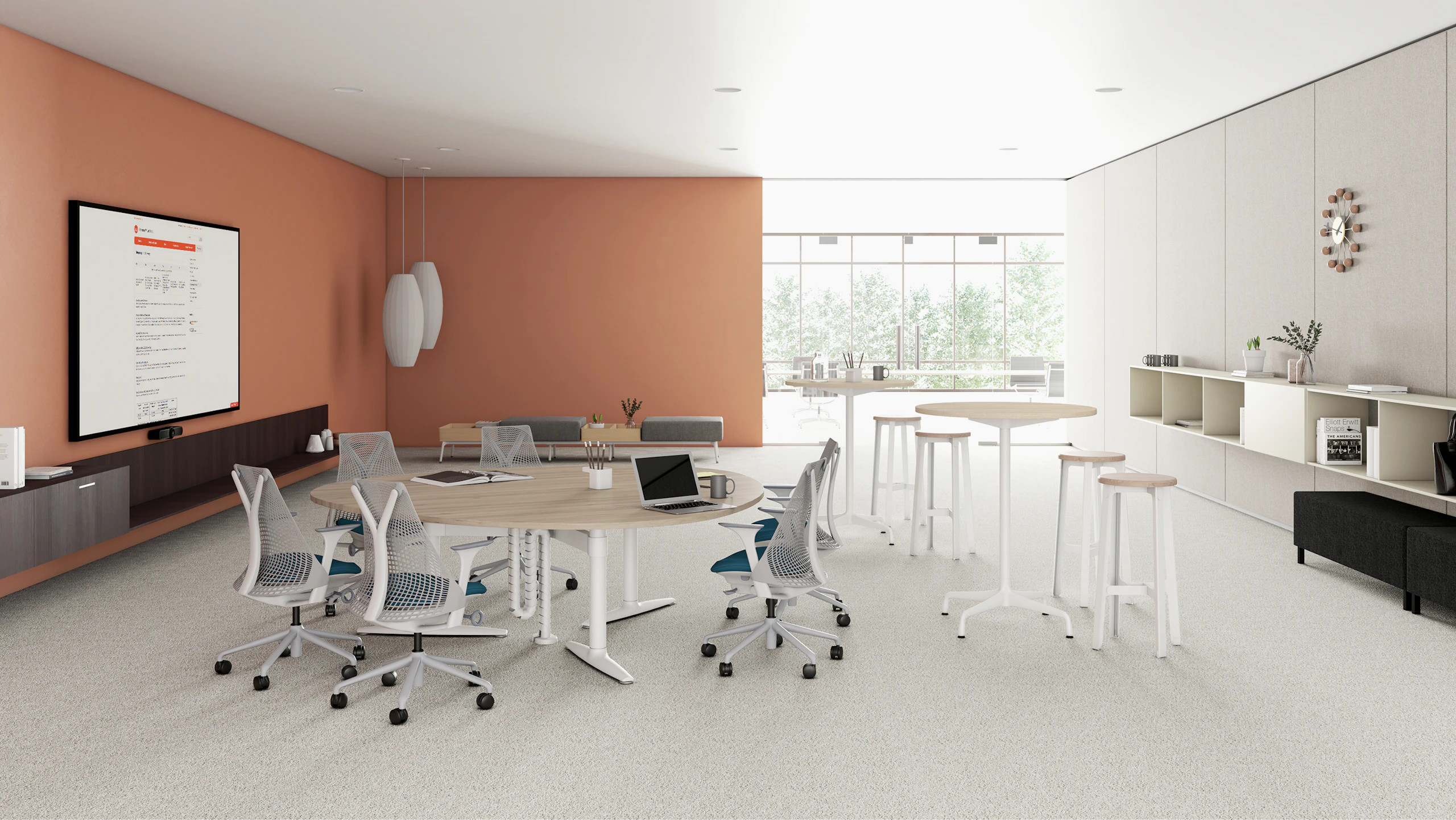 A video conferene collboration space setting featuring a Shift Levels guitar pick table with Sayl Chairs, Sabha Collaborative Seating, Also featuring Nelson Bubble Lamps and Construct Stools.