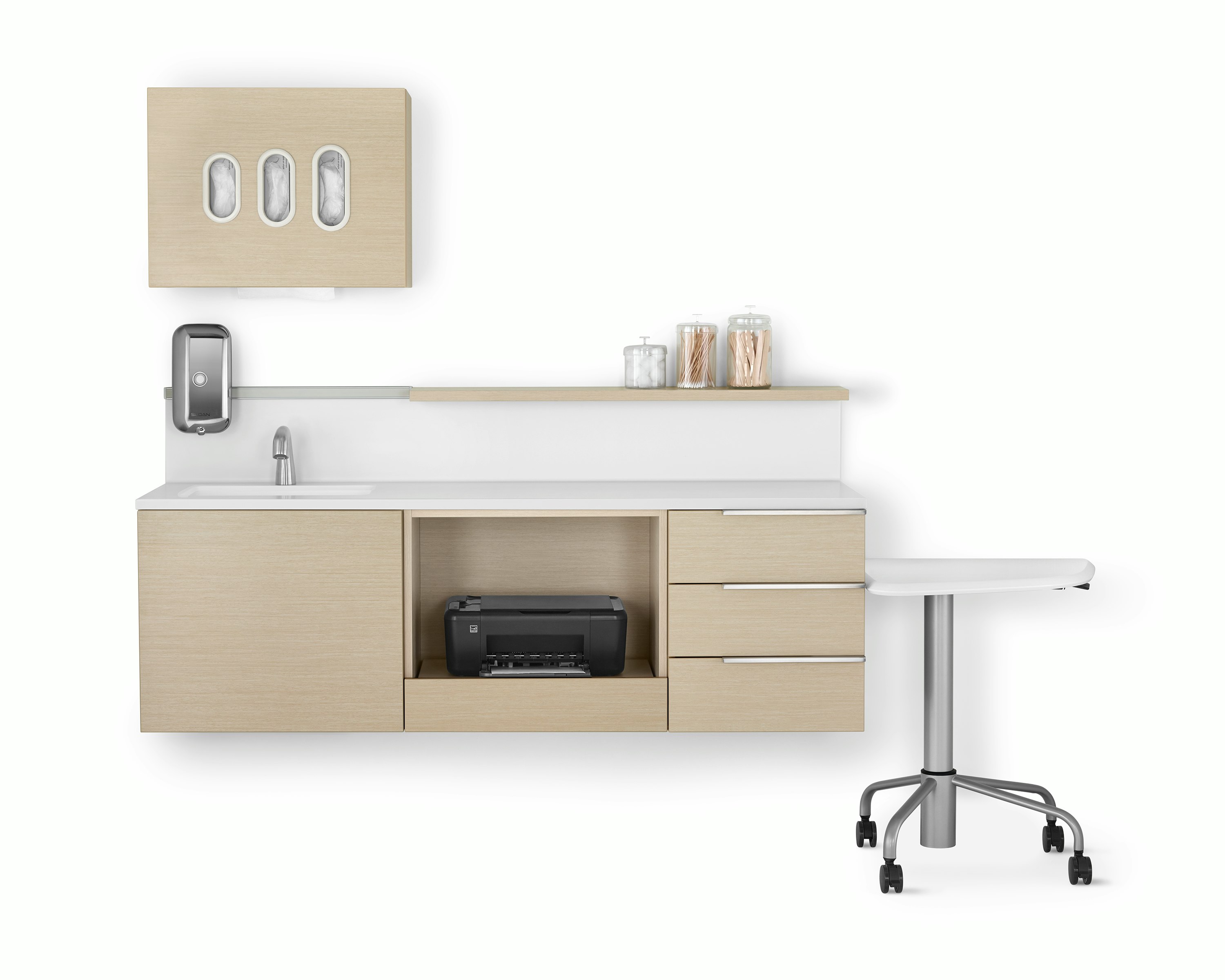 Mora casework in an ash finish with an upper glove storage unit and a lower wall-hung unit with a printer storage cabinet, drawer cabinets, and a sink and surface in a white solid surface. An Intent mobile table is placed next to the storage cabinet.