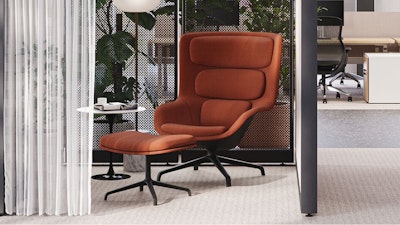 A burnt-orange lounge chair next to a black and white Knoll Saarinen side table in an individual respite space created using Knoll Rockwell Unscripted Creative Walls