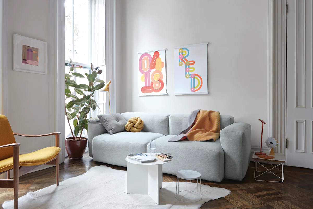 Elegant blue sofa with wooden side tables in a bright room