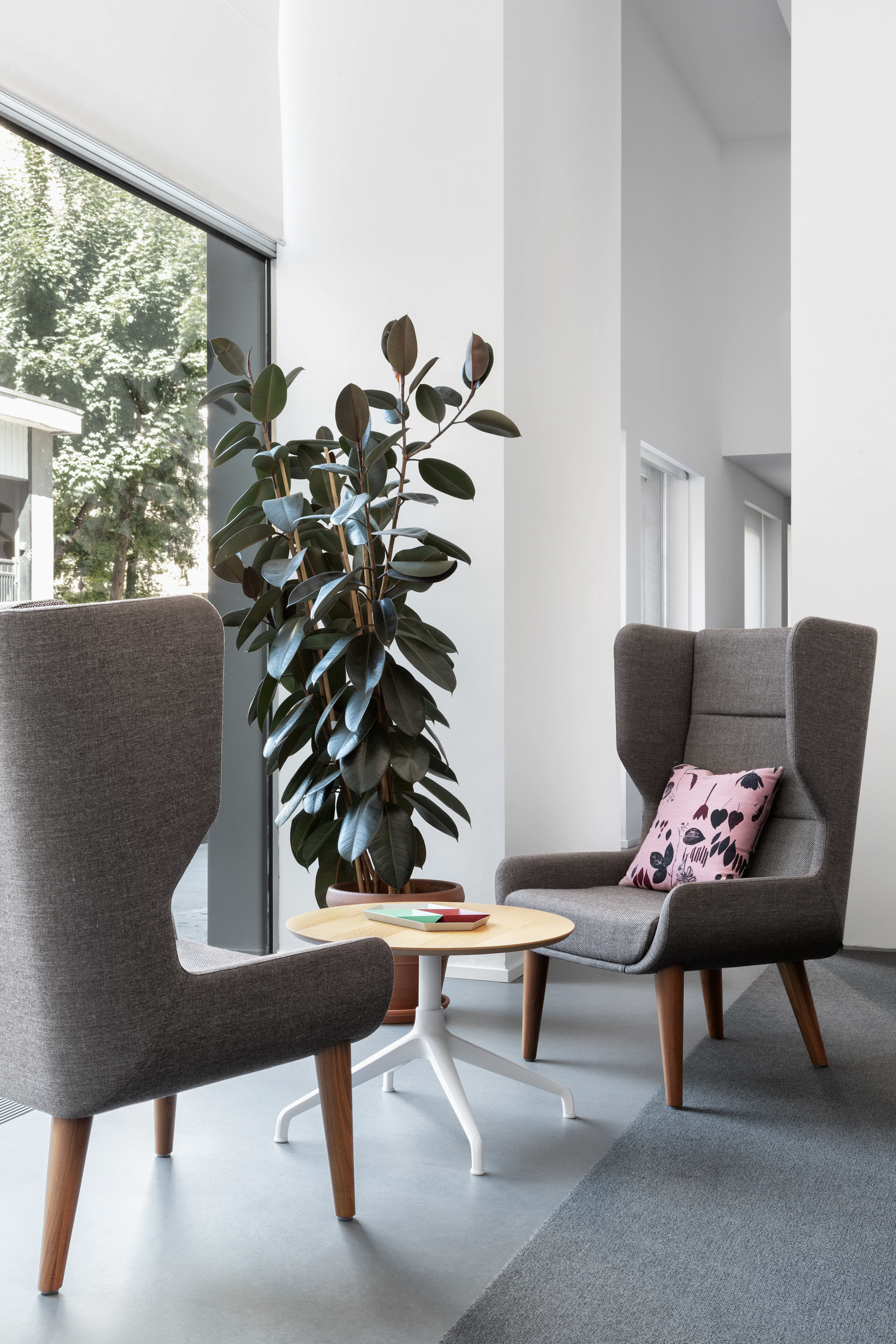 Two Hush Chairs and an Ali table next to a window.