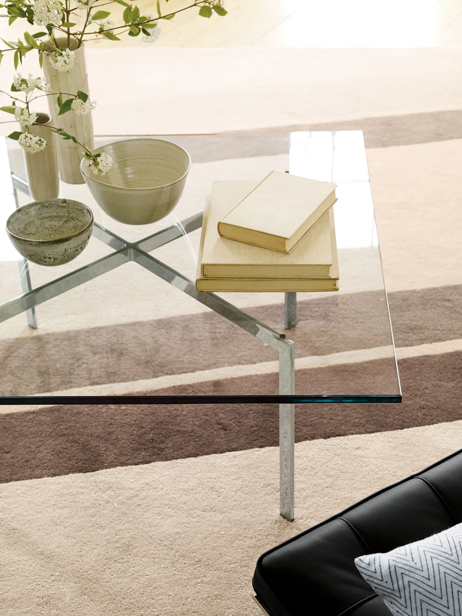 Glass dining table with rectangular clear glass top and metal legs