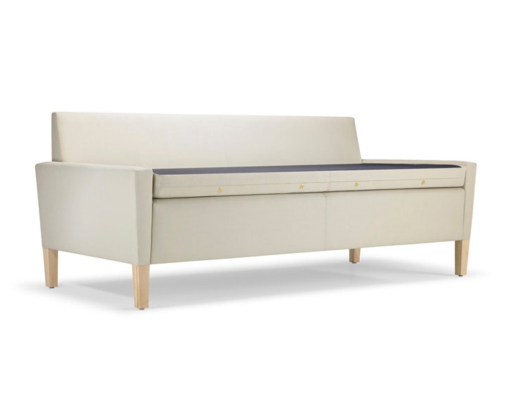 A Brava Flop Sofa in white textile with maple legs ready to unfold.