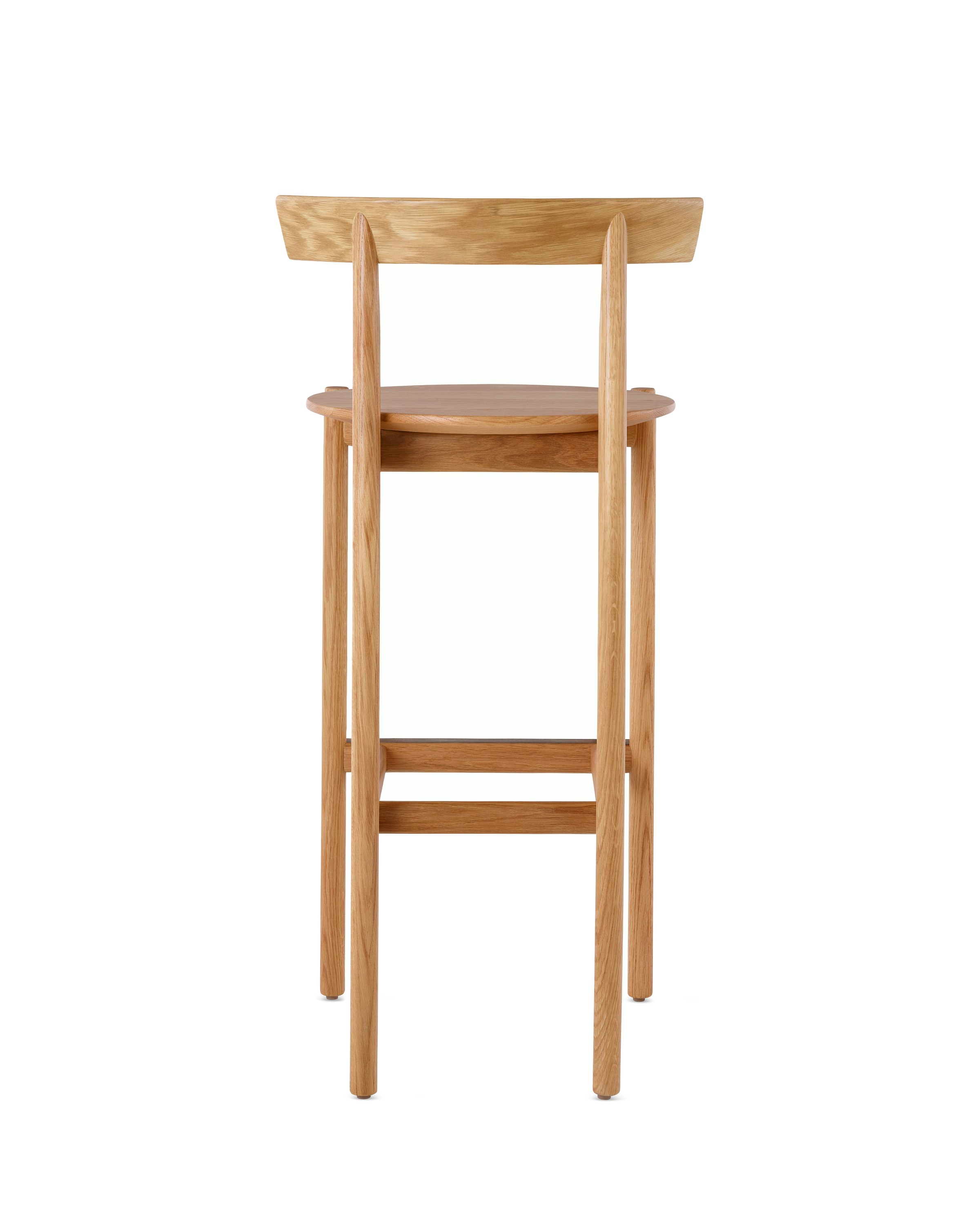 An oak bar-height Comma Stool, viewed from the back. 