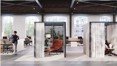 An open, brightly lit space with brick walls and floor-to-ceiling windows featuring Knoll Rockwell Unscripted Creative Walls, Saarinen Side Tables, burnt-orange lounge chairs, and lighting from Design Within Reach