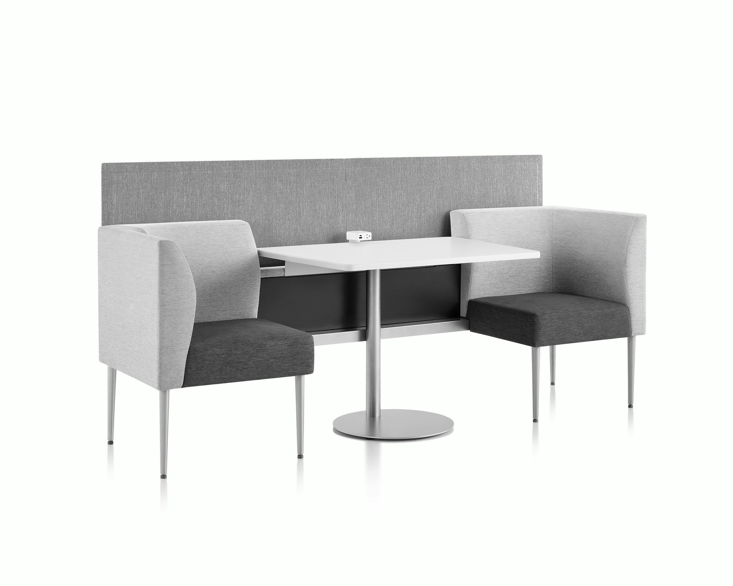 Three-quarter view of Palisade booths with table and power module in the middle and privacy screen.