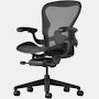 Black matte Aeron Chair on a white background with a 5-star base and ergonomic back support, angled view of the chair front.